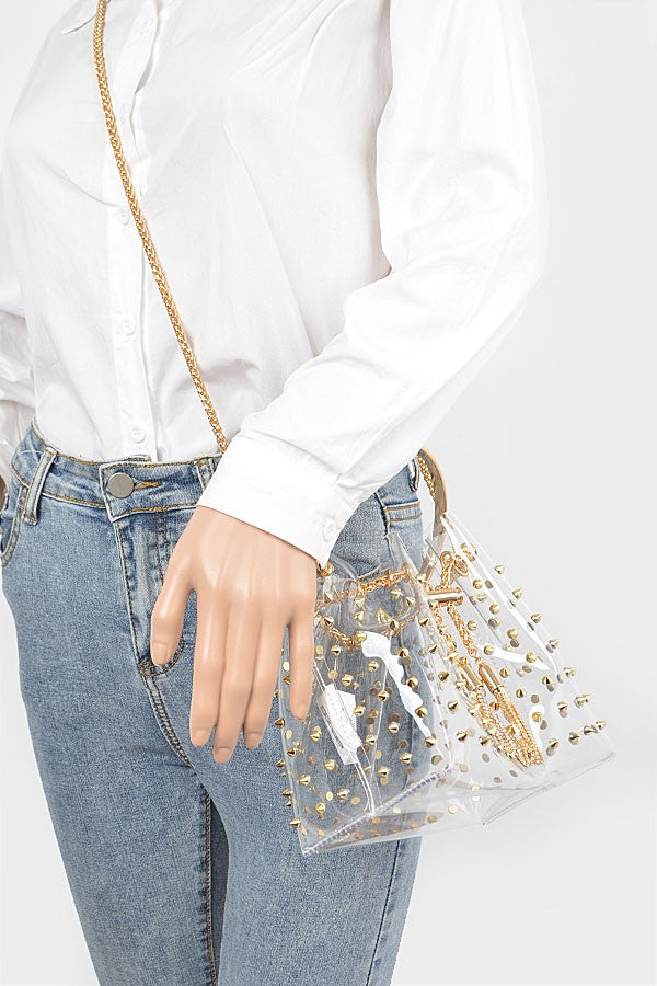 Bolso tipo cubo con tachuelas de metal transparente y borla de cadena
